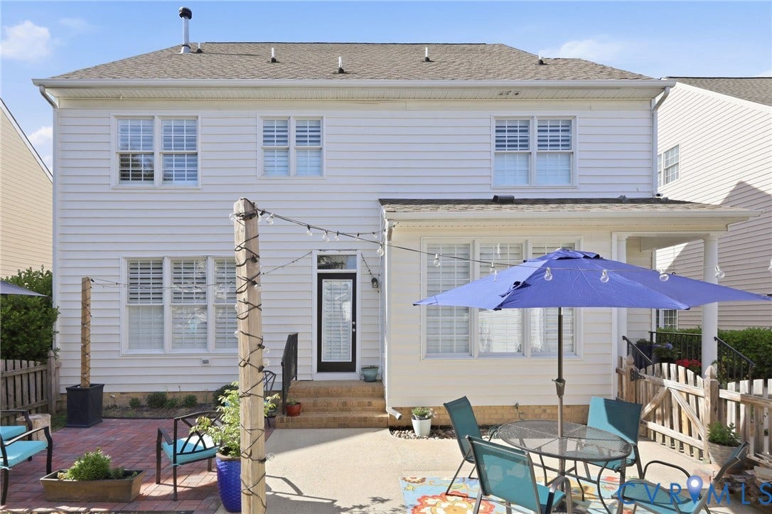 4909 Parsons Walk Place, Twin Hickory, Glen Allen, VA 23059 Rear exterior featuring white horizontal siding, a covered patio area, and a private back entrance with a black door