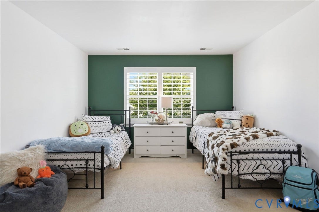4909 Parsons Walk Place, Twin Hickory, Glen Allen, VA 23059 Spacious room featuring neutral carpeting, white walls, and an accent wall in a deep green hue