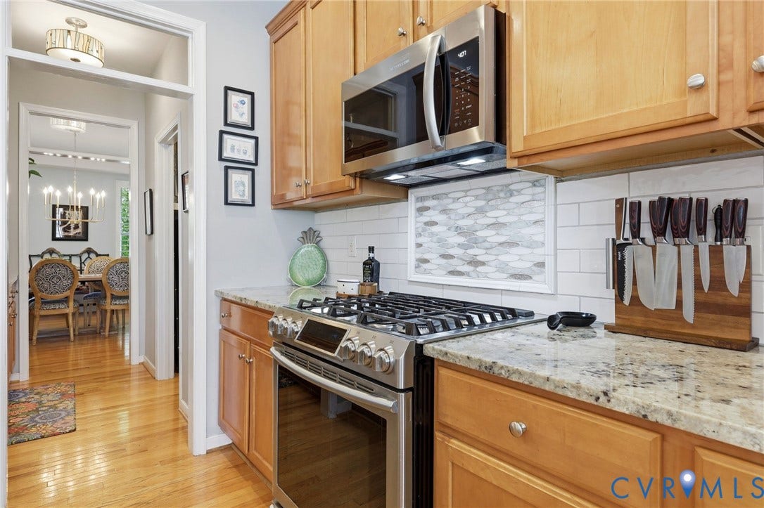 4909 Parsons Walk Place, Twin Hickory, Glen Allen, VA 23059 Kitchen featuring light wood cabinetry, stainless steel appliances, granite countertops, and a subway tile backsplash