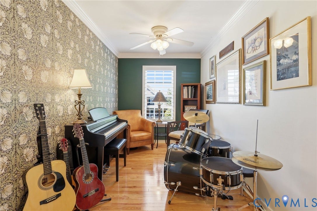 4909 Parsons Walk Place, Twin Hickory, Glen Allen, VA 23059 Room featuring wood-finish flooring, a decorative accent wall with floral wallpaper, a ceiling fan with integrated lighting, and crown molding