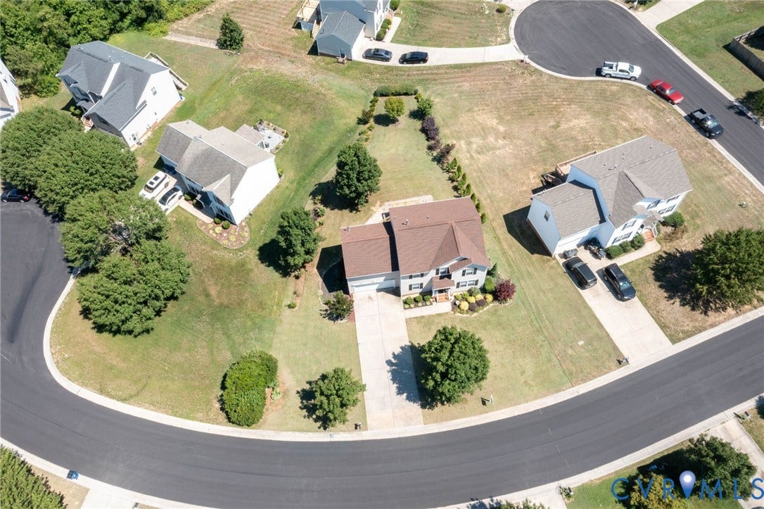 Residential property with a multi-level roofline, an attached two-car garage, and a concrete driveway