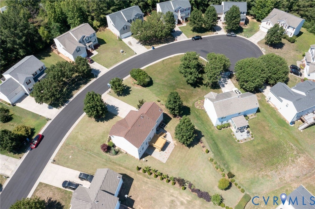 Aerial perspective showcasing a residential street with multiple detached homes