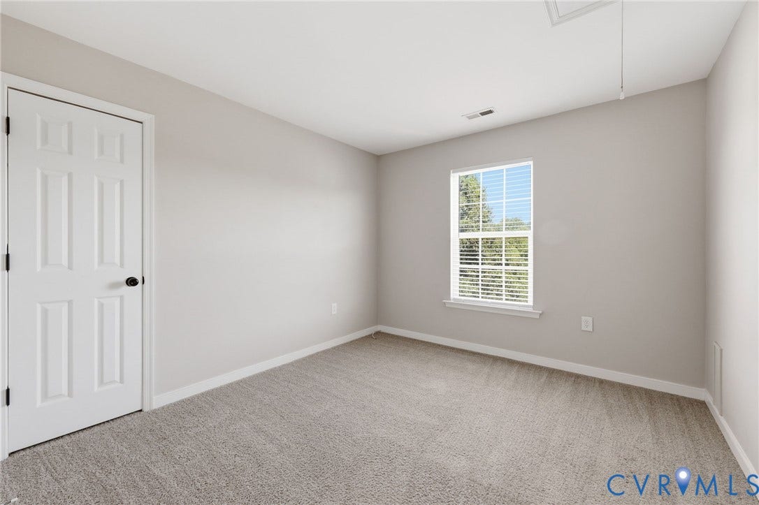 Neutral tone walls and carpeting create a versatile interior