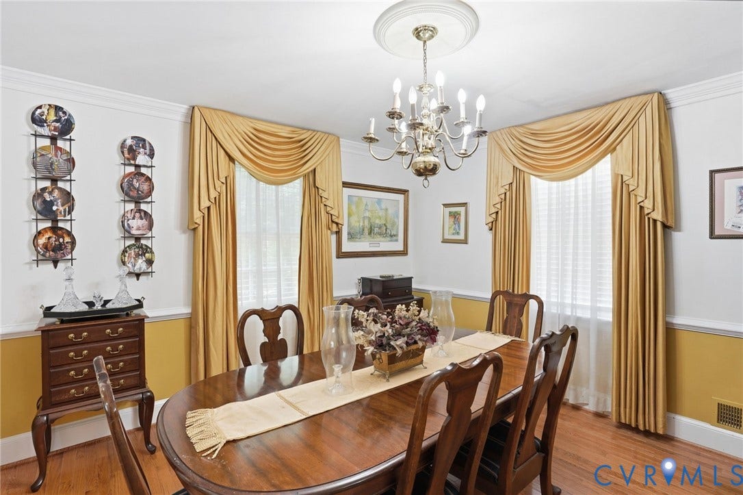 11016 Pridesville Road, Amelia, VA 23002 Formal dining space featuring wood-finish flooring, a two-tone painted wall, crown molding, and a chandelier with a ceiling medallion