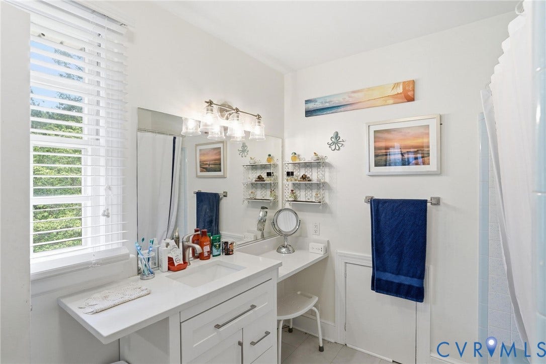 11016 Pridesville Road, Amelia, VA 23002 Bathroom featuring a white vanity with integrated sink, a window with horizontal blinds, and a built-in shower