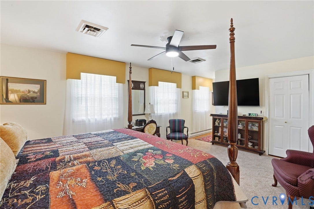 11016 Pridesville Road, Amelia, VA 23002 Carpeted room featuring multiple windows with blinds, a ceiling fan with integrated lighting, and a closet with bifold doors