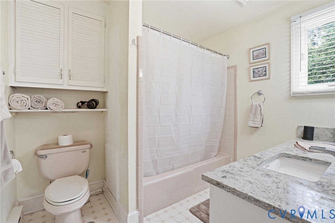 11016 Pridesville Road, Amelia, VA 23002 Bathroom featuring a granite-look countertop, integrated sink, and white vanity cabinetry