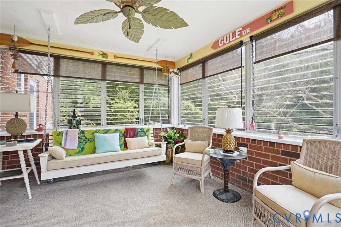 11016 Pridesville Road, Amelia, VA 23002 Screened porch with a white swing, brick knee wall, wood-finish ceiling fan, and large windows with blinds