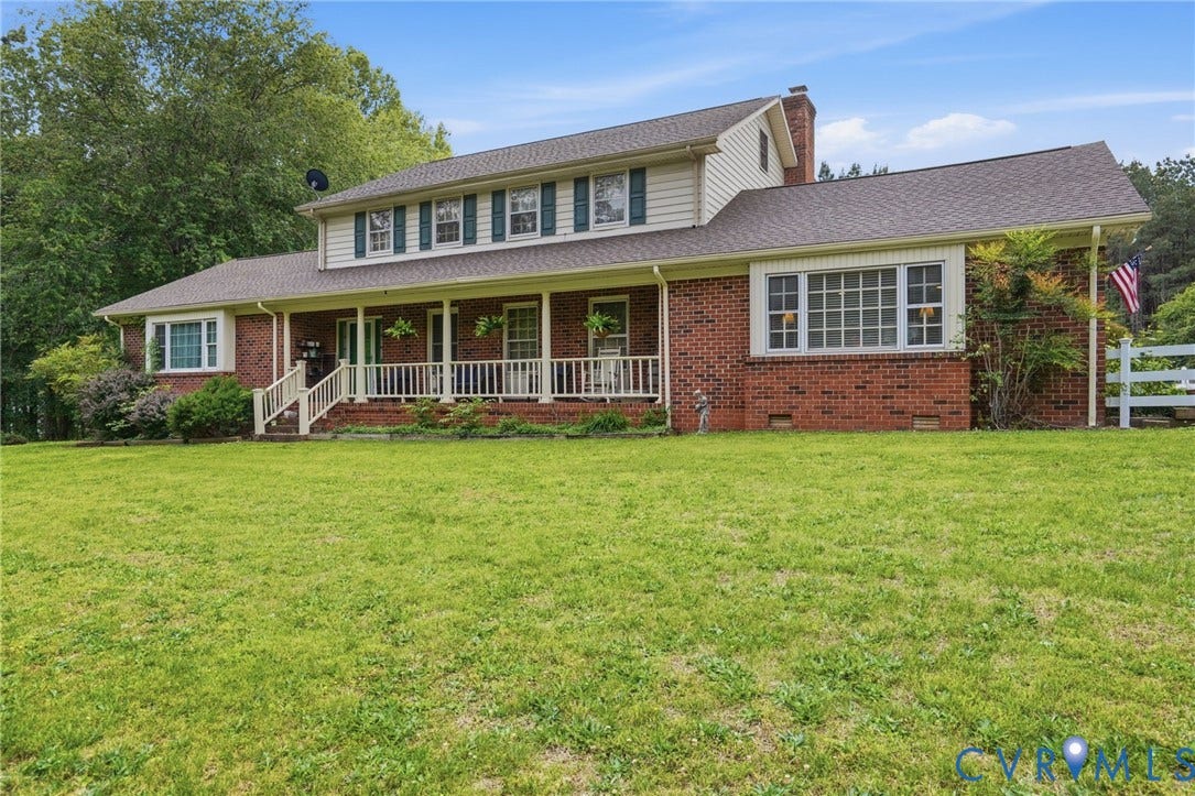 11016 Pridesville Road, Amelia, VA 23002 Traditional brick exterior with white siding accents and a covered front porch featuring white railings