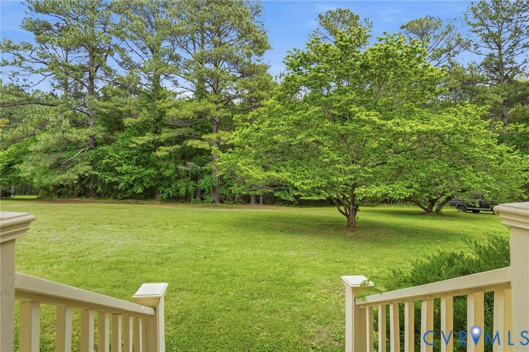 11016 Pridesville Road, Amelia, VA 23002 Expansive green lawn framed by mature trees, offering a serene outdoor environment