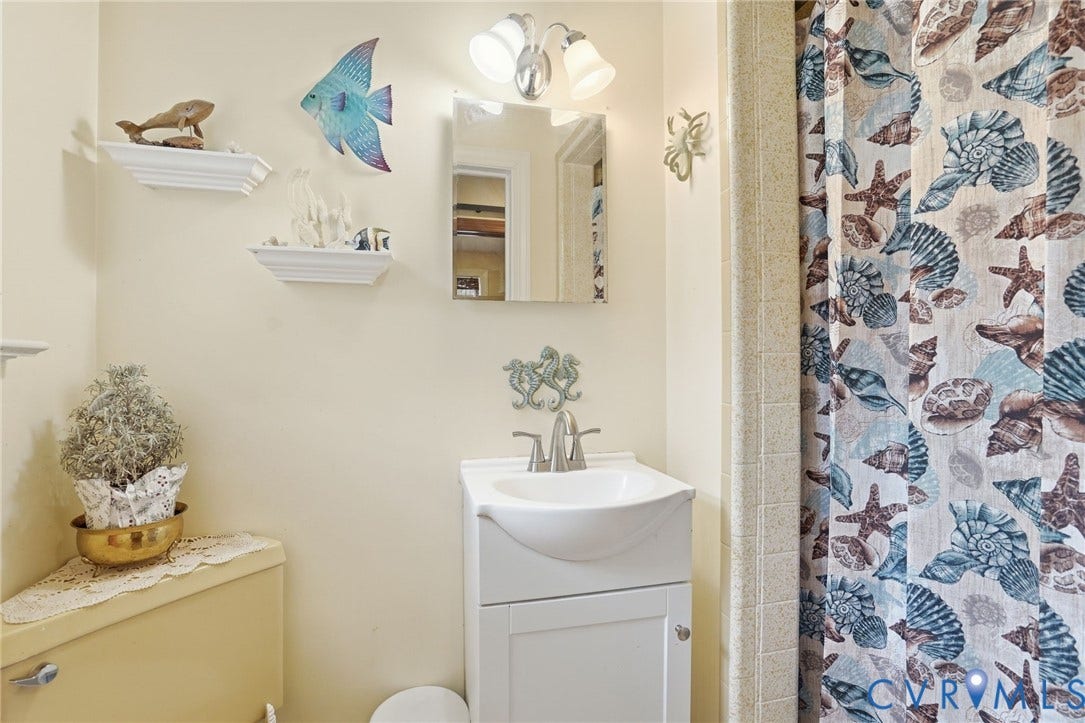 11016 Pridesville Road, Amelia, VA 23002 Bathroom featuring a white vanity with an integrated sink, brushed nickel faucet, and a wall-mounted medicine cabinet