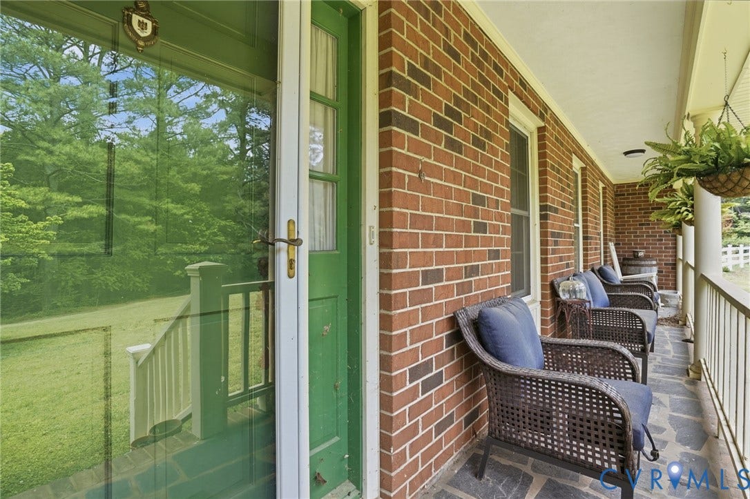 11016 Pridesville Road, Amelia, VA 23002 Brick exterior featuring a covered porch with flagstone flooring