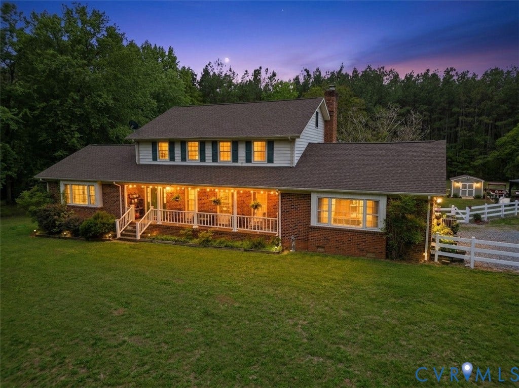 11016 Pridesville Road, Amelia, VA 23002 Brick and siding exterior featuring a covered front porch with white railing, dormer windows, and a prominent chimney