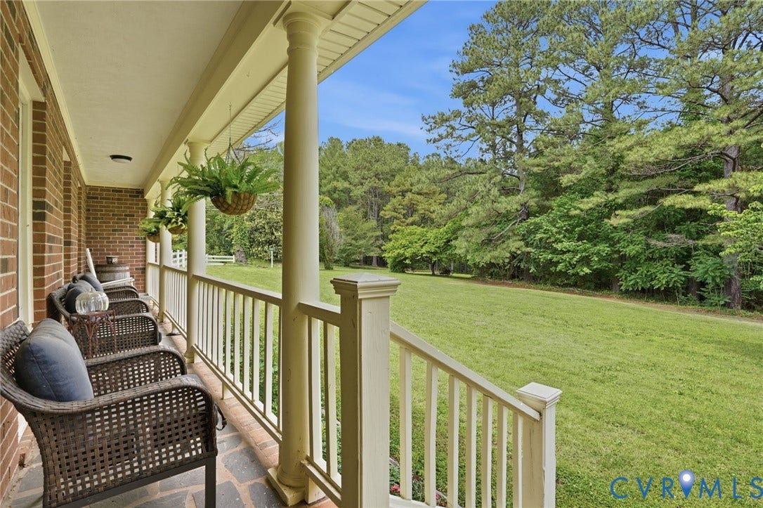 11016 Pridesville Road, Amelia, VA 23002 Front porch featuring brick facade, classic columns, and a stone-finish floor