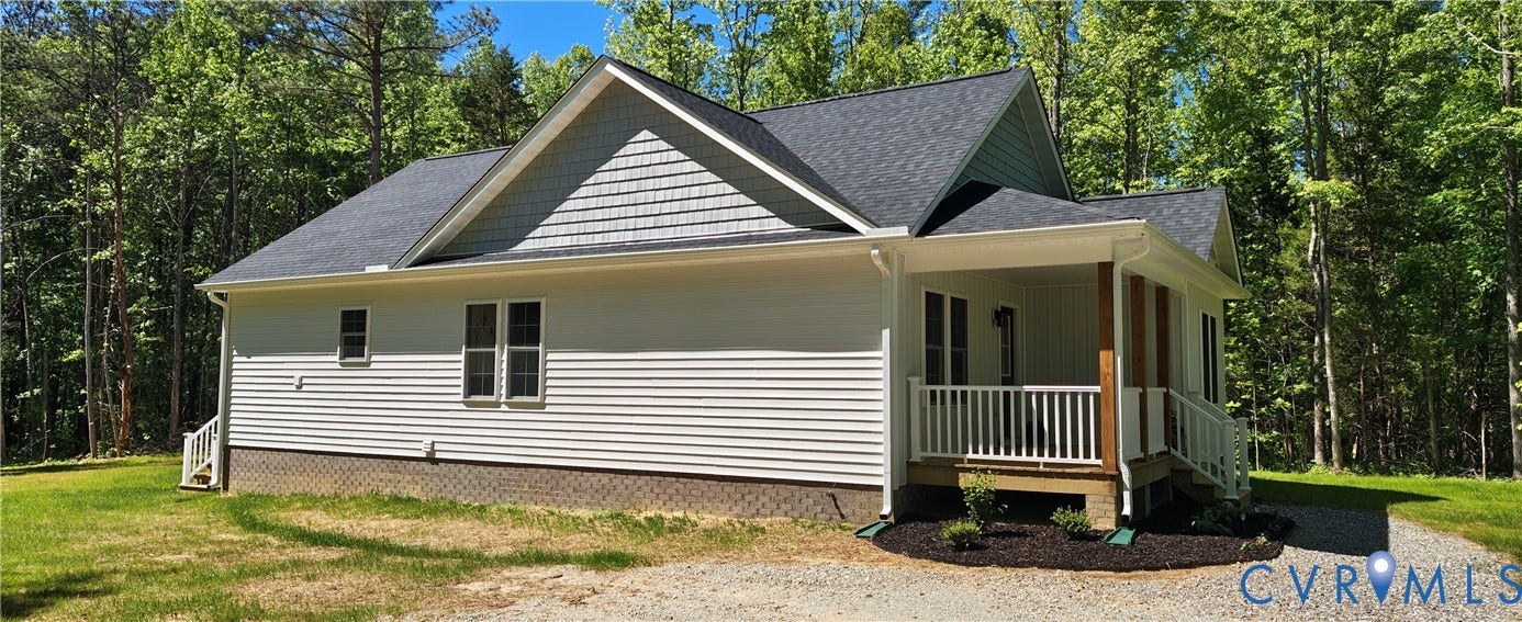 Ranch-style residence featuring white horizontal siding, a covered front porch with white railings, and a dark shingle roof