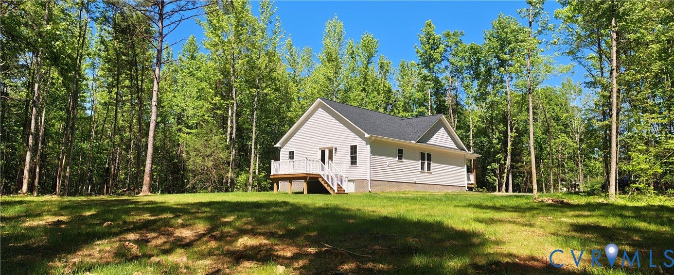 Newly constructed residence featuring a white exterior and a dark shingle roof