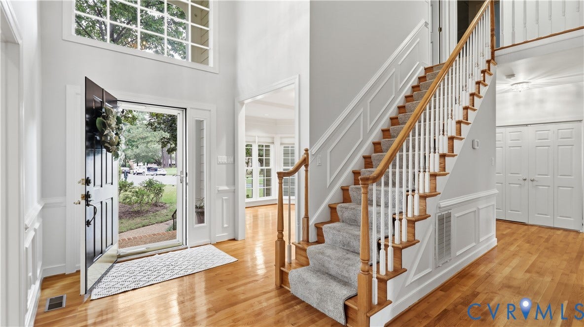 12400 Chadsworth Place, Wyndham, Glen Allen, VA 23059 Two-story foyer featuring wood-finish flooring, wainscoting, and a grand staircase with carpeted treads and wood railings