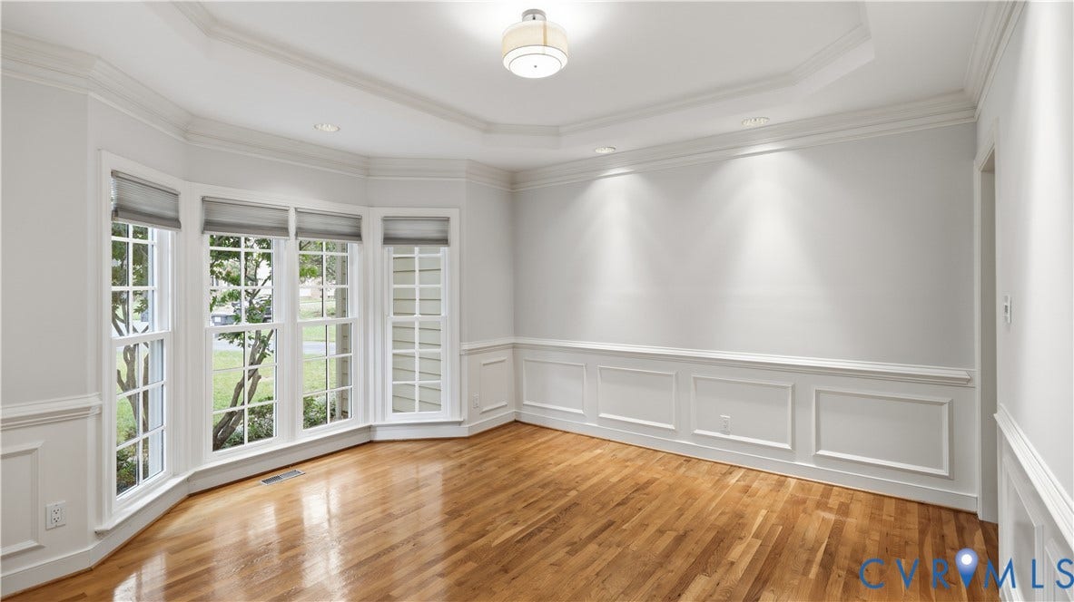 12400 Chadsworth Place, Wyndham, Glen Allen, VA 23059 Bay window with multiple panes, wood-finish flooring, extensive crown molding, recessed lighting, and wall paneling