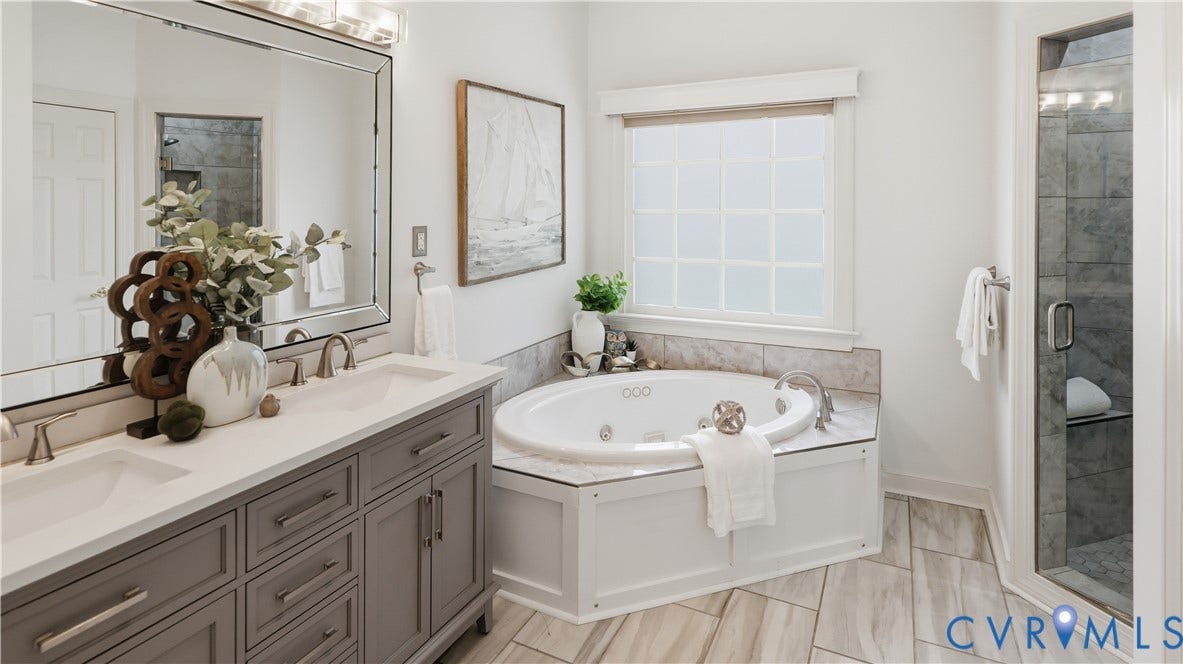 12400 Chadsworth Place, Wyndham, Glen Allen, VA 23059 Spacious bathroom featuring a dual vanity with a light countertop, a corner jetted tub, a window with privacy glass, a glass-enclosed shower, and wood-finish tile flooring