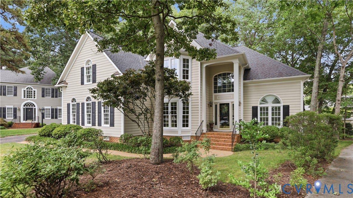 12400 Chadsworth Place, Wyndham, Glen Allen, VA 23059 Exterior with light-colored siding, dark shutters, prominent gabled and arched windows, a covered entry with columns, and a brick-detailed staircase