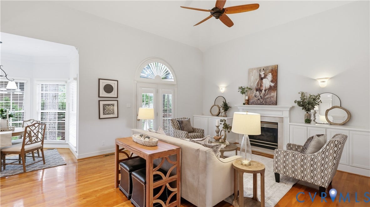 12400 Chadsworth Place, Wyndham, Glen Allen, VA 23059 Living area featuring vaulted ceilings with a ceiling fan, hardwood flooring, and a fireplace with a mantel flanked by built-in cabinetry