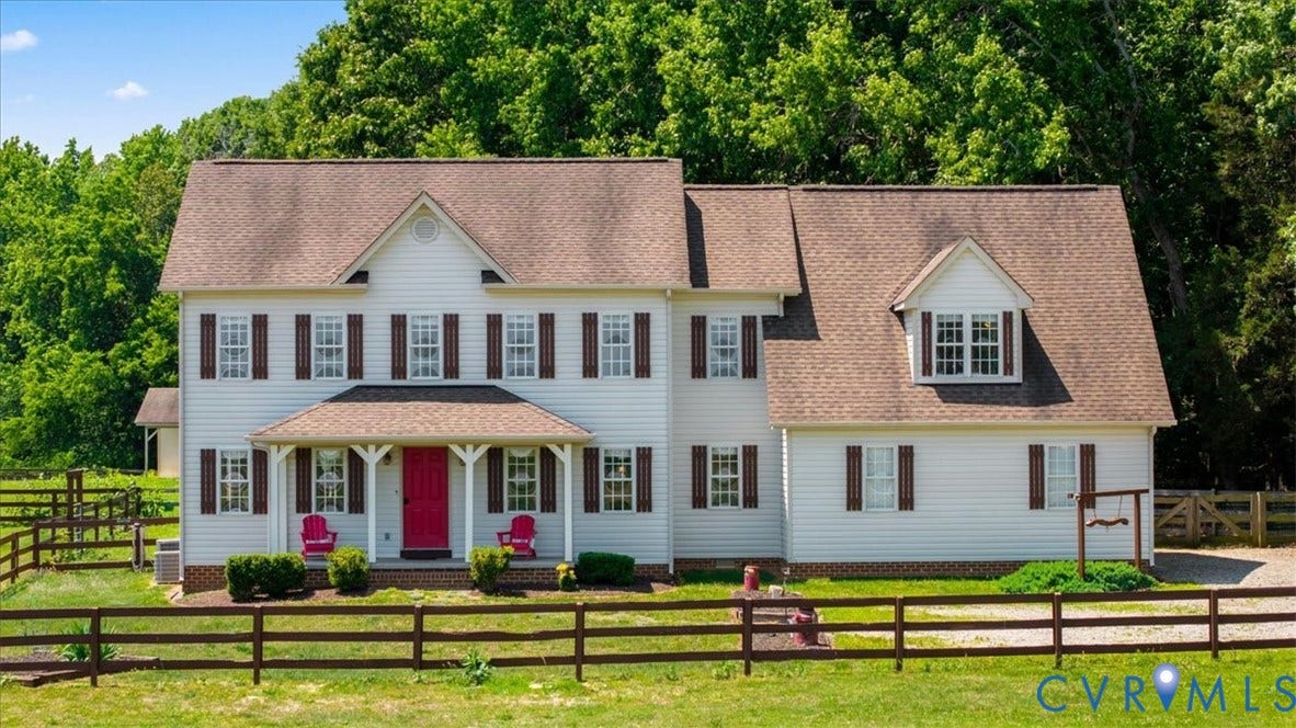 Two-story residence featuring white siding and a brown shingle roof