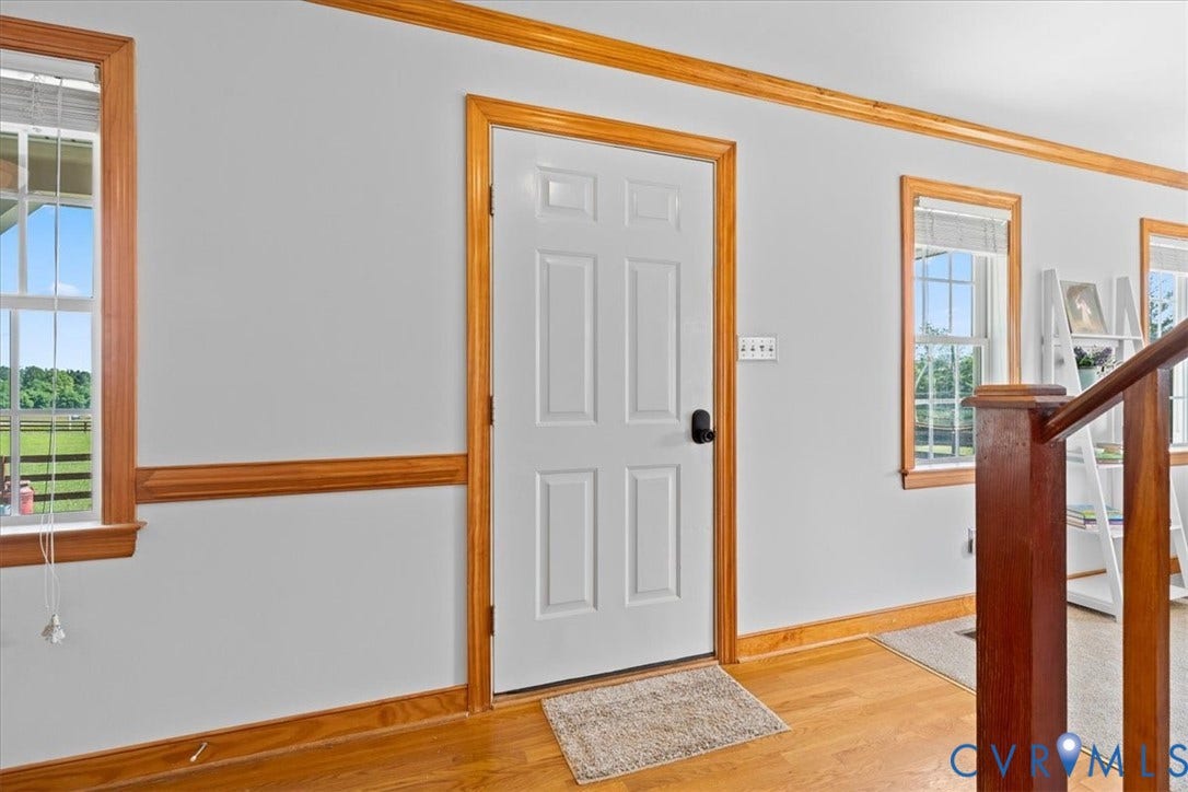 Wood-finish flooring throughout, complemented by wood trim and white walls