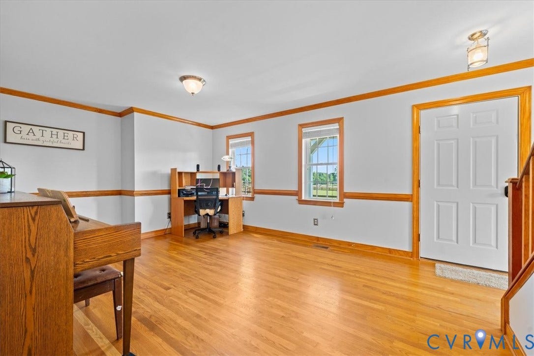 Fireplace with a wood mantle, wood-finish flooring, wood cabinetry, stone countertops, and recessed lighting