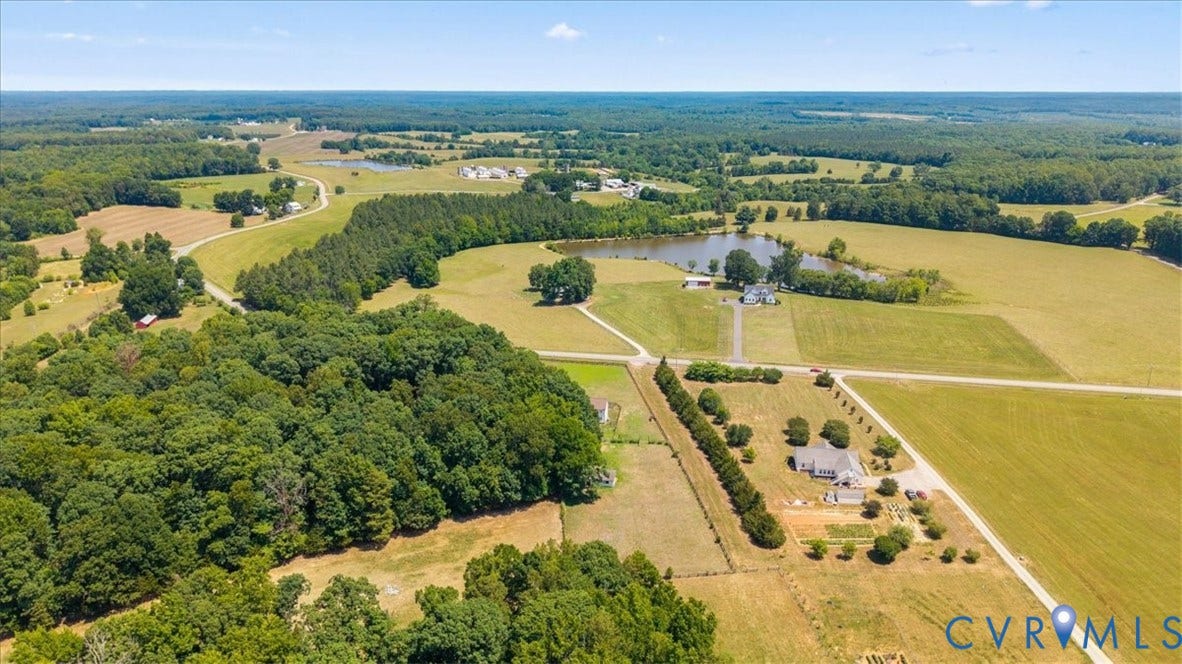 Expansive aerial view showcasing extensive wooded areas and open fields