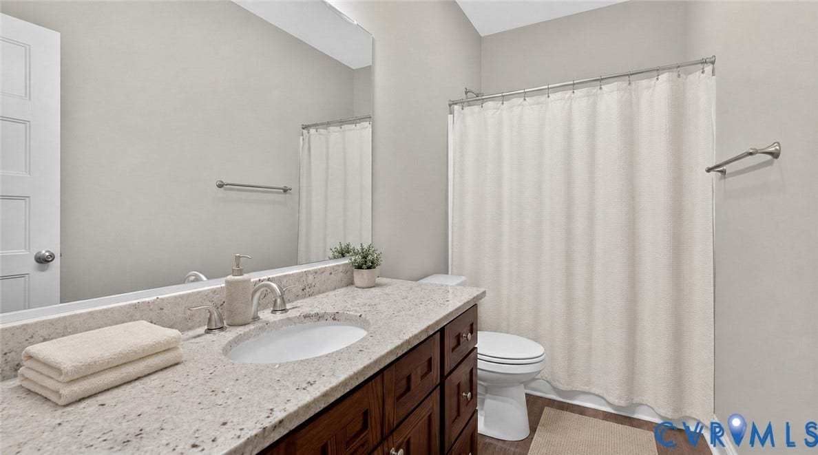 3834 Three Chopt Road, Nonw, Goochland, VA 23065 Bathroom featuring a spacious vanity with a light-toned countertop, an undermount sink, and a dark wood-finish cabinet