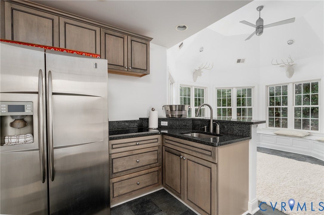 3124 Rock Cress Lane, Mill Forest, Sandy Hook, VA 23153 Efficient Pool House Kitchen has a GE side-by-side fridge, L-shaped granite-topped counter with Miele smooth top four burner and deep stainless sink. Raised pull up bar adjoins Solarium.