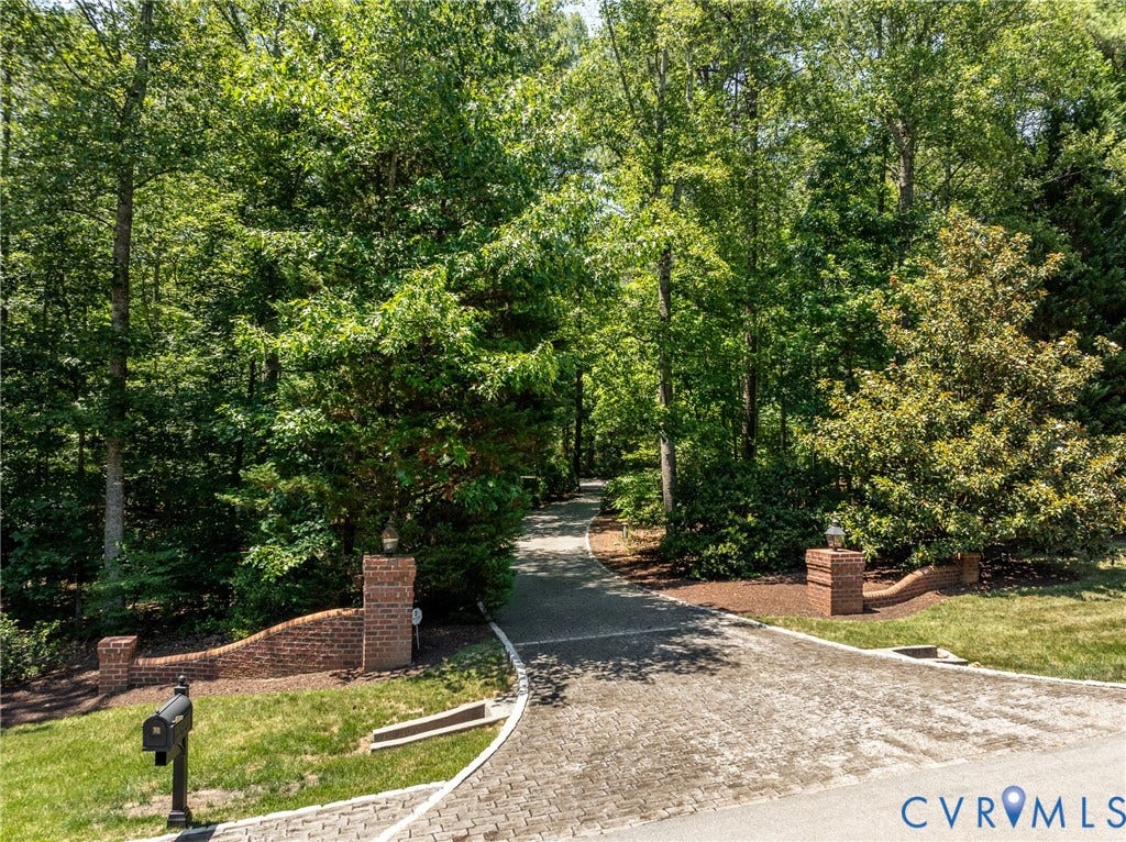 3124 Rock Cress Lane, Mill Forest, Sandy Hook, VA 23153 Brick pillars, graciously curved brick walls and a cobblestone bordered drive begin the meandering approach to this private property, completely shielded from the road.