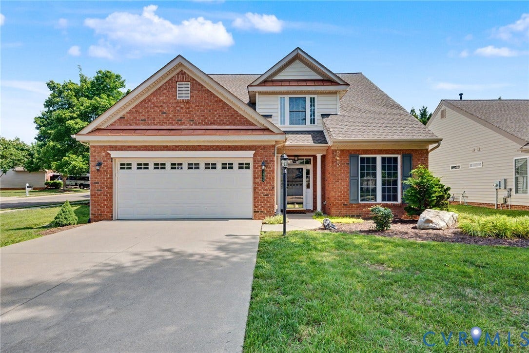 Brick exterior with a shingled roof and gabled accents