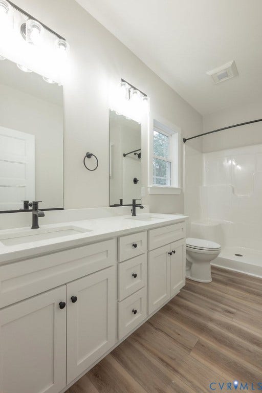 9256 Fredericks Hall Road, Con Creek, Mineral, VA 23117 Dual vanity with white cabinetry and integrated sinks