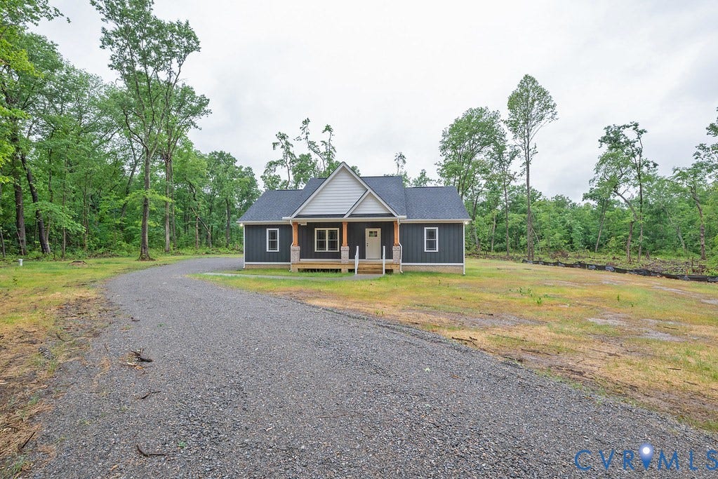 9256 Fredericks Hall Road, Con Creek, Mineral, VA 23117 Single-story residence featuring dark gray siding and a light-colored gable