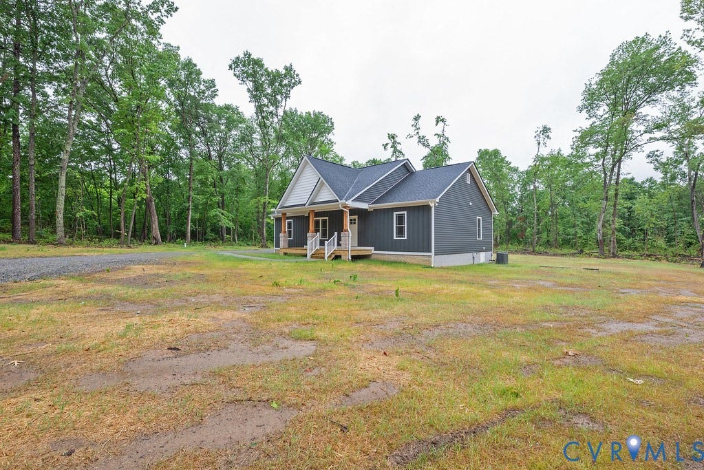 9256 Fredericks Hall Road, Con Creek, Mineral, VA 23117 New construction residence featuring dark gray siding with white trim accents and a contrasting white gable