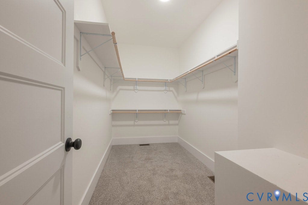 9256 Fredericks Hall Road, Con Creek, Mineral, VA 23117 Walk-in closet featuring carpet flooring, built-in shelving, and hanging rods