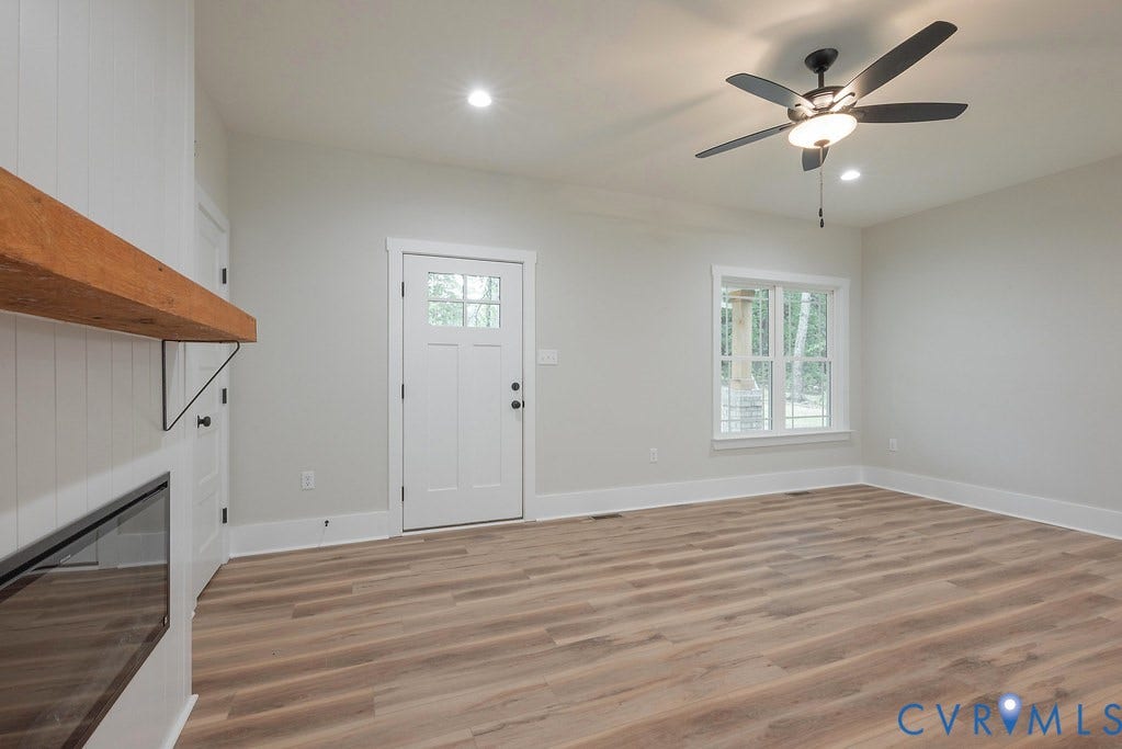 9256 Fredericks Hall Road, Con Creek, Mineral, VA 23117 Spacious room featuring wood-finish flooring, recessed lighting, and a contemporary ceiling fan