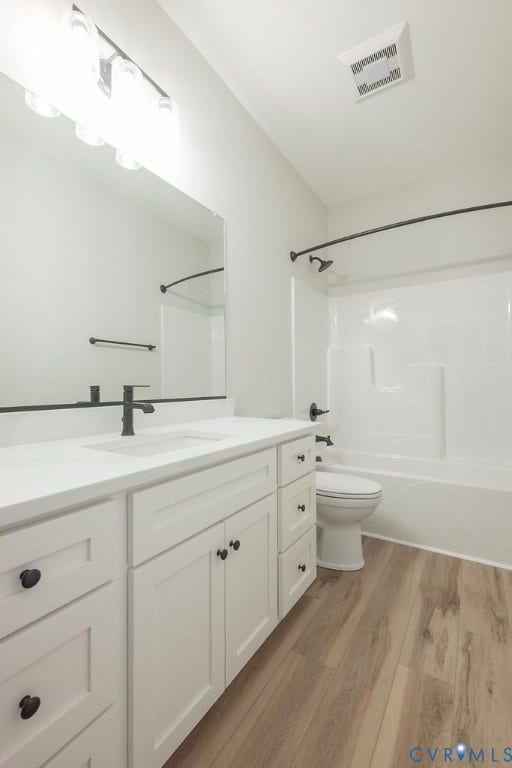 9256 Fredericks Hall Road, Con Creek, Mineral, VA 23117 White vanity with a solid surface countertop, an integrated sink, and matte black fixtures