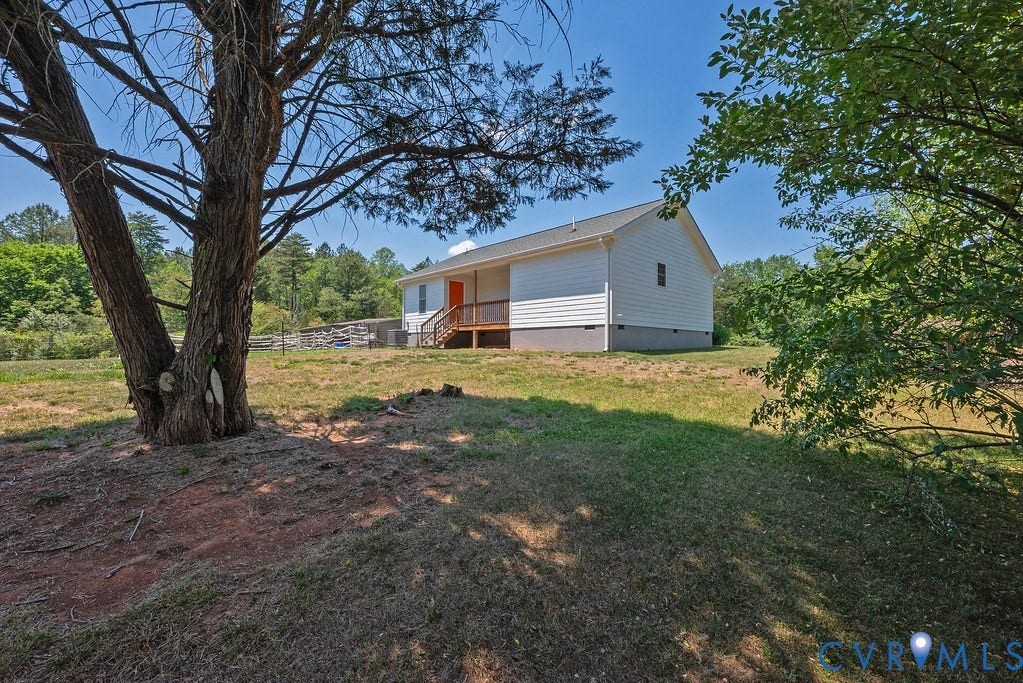 4336 Hells Bend Road, Quiet And Private, Palmyra, VA 22963 Property exterior featuring white siding, a contrasting orange entry door, and a raised wooden deck with railings