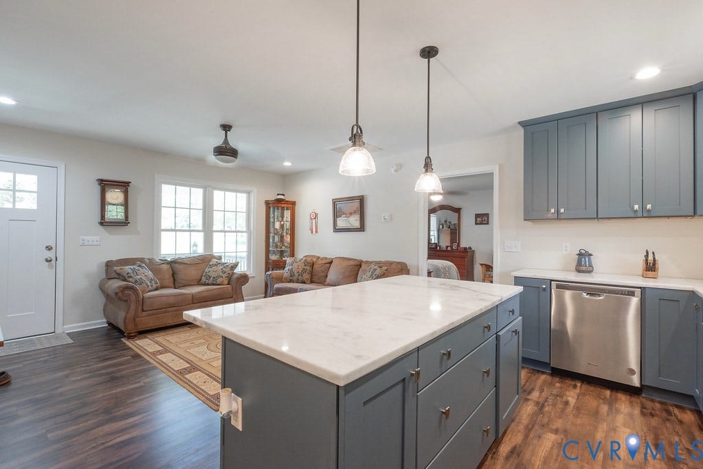 4336 Hells Bend Road, Quiet And Private, Palmyra, VA 22963 Kitchen island featuring a white countertop and blue-grey cabinetry with contemporary hardware, complemented by pendant lighting