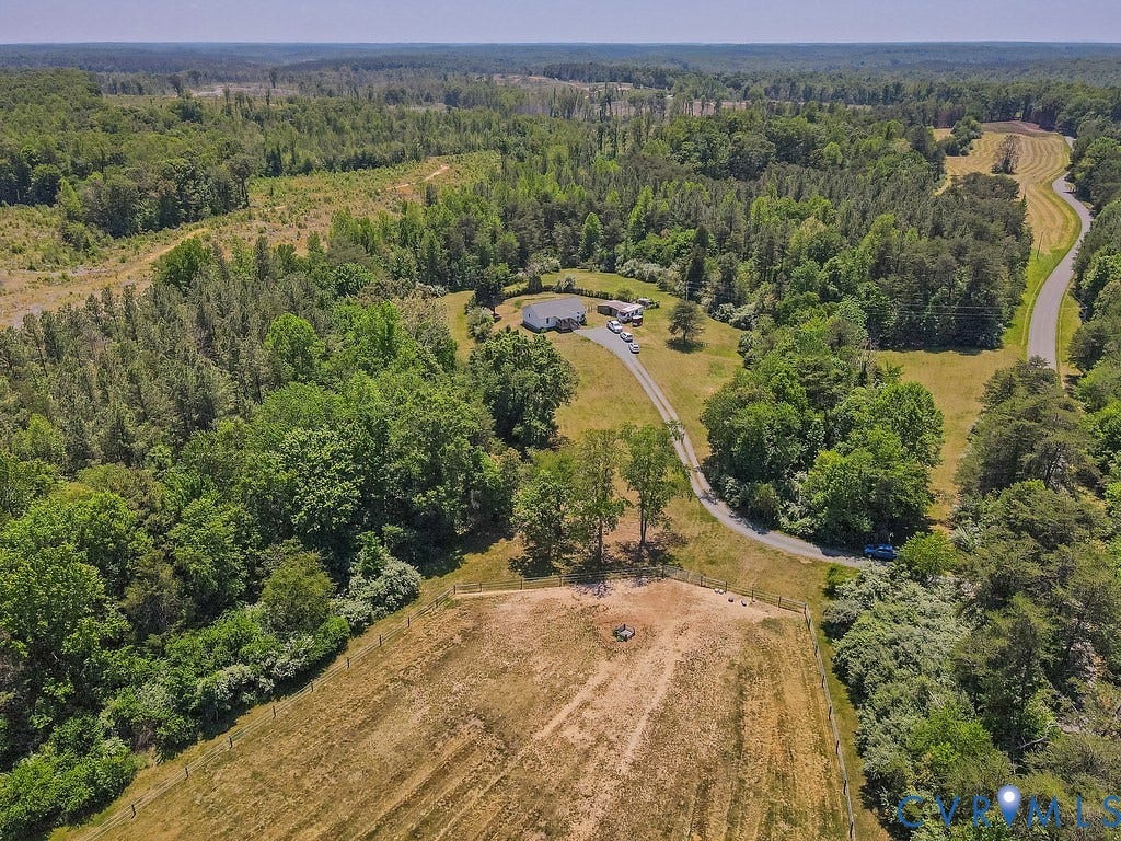 4336 Hells Bend Road, Quiet And Private, Palmyra, VA 22963 Sprawling wooded property featuring a single-story residence, a private driveway, open fields, and a paved road frontage