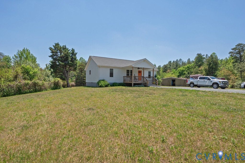 4336 Hells Bend Road, Quiet And Private, Palmyra, VA 22963 White siding residence featuring a covered front porch, a gravel driveway, and a detached storage shed