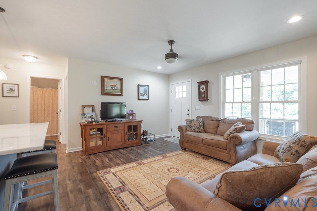 4336 Hells Bend Road, Quiet And Private, Palmyra, VA 22963 Bright living space featuring wood-finish flooring, white trim, and multiple large windows