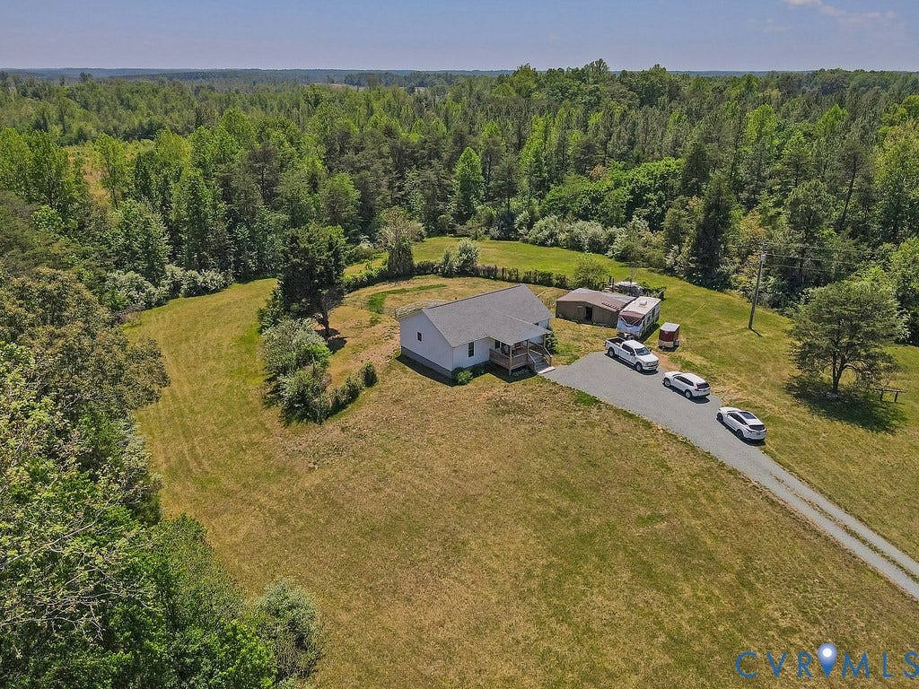 4336 Hells Bend Road, Quiet And Private, Palmyra, VA 22963 Spacious property featuring a single-story residence with a gray shingle roof, a gravel driveway, and surrounding green acreage