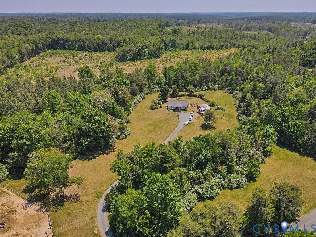 4336 Hells Bend Road, Quiet And Private, Palmyra, VA 22963 Expansive property featuring a central residence, outbuilding, and gravel driveway, surrounded by mature trees and cleared land