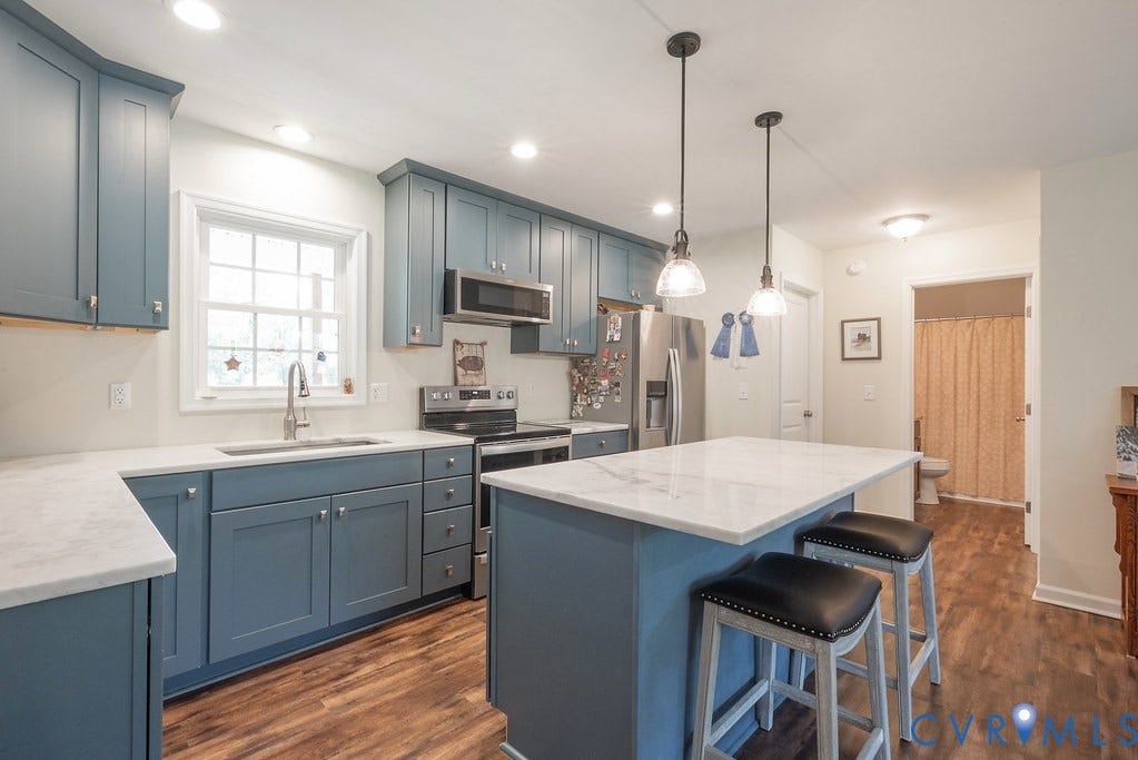 4336 Hells Bend Road, Quiet And Private, Palmyra, VA 22963 Kitchen featuring blue shaker-style cabinetry with chrome hardware, white countertops, and wood-finish flooring