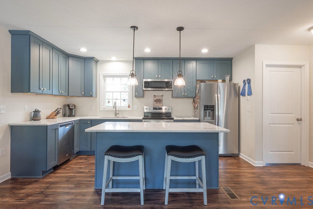 4336 Hells Bend Road, Quiet And Private, Palmyra, VA 22963 Kitchen featuring blue cabinetry, a central island with countertop, stainless steel appliances, and wood-finish flooring