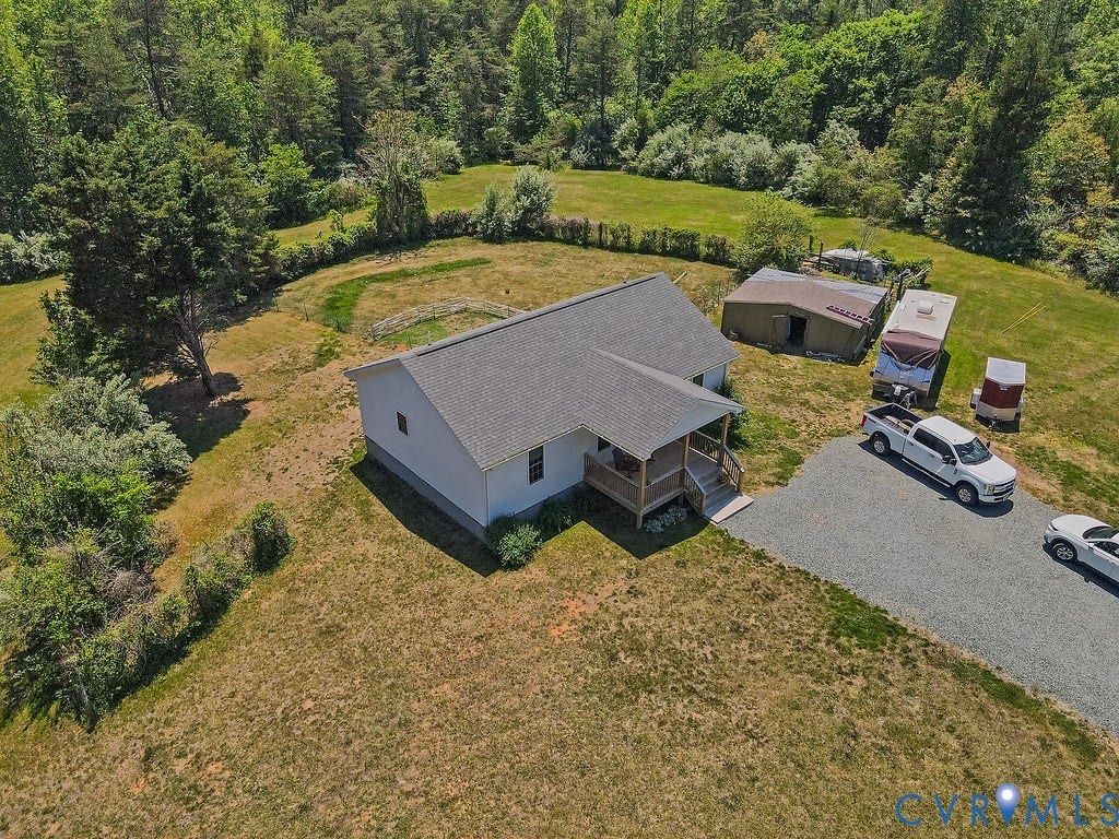4336 Hells Bend Road, Quiet And Private, Palmyra, VA 22963 Single-story residence featuring a covered front porch with wood railings and steps, a gravel driveway, a detached shed, and surrounding mature trees