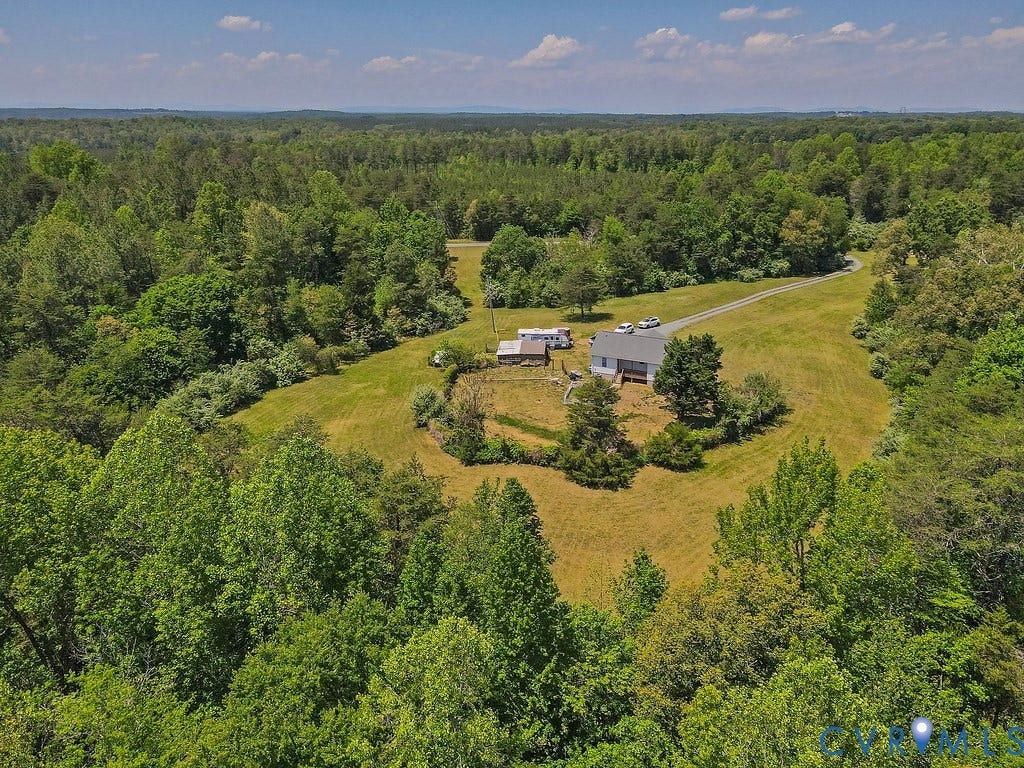 4336 Hells Bend Road, Quiet And Private, Palmyra, VA 22963 Expansive property featuring a single-story residence, a gravel driveway, and surrounding wooded acreage